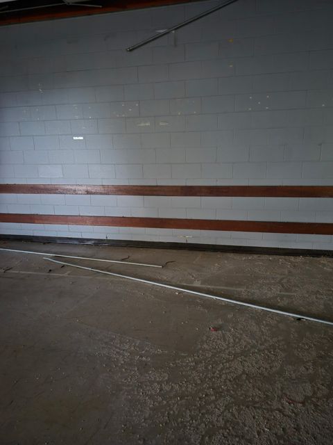 Wall and floor debris before cleanup