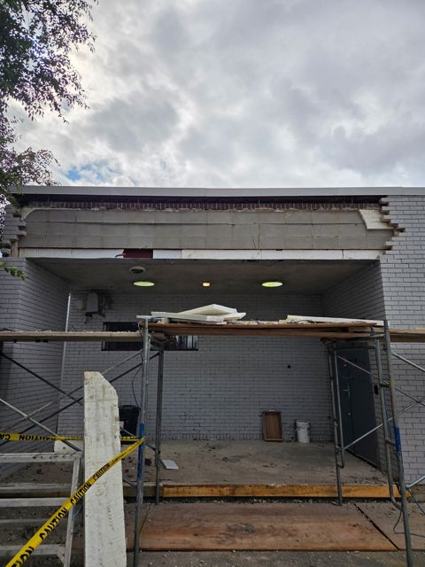 Brick removed, scaffold and hoarding in place