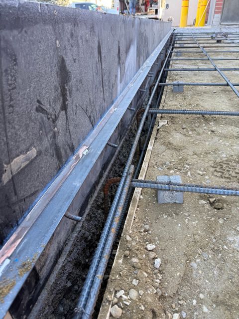 Ramp edge steel and reinforcing along the wall